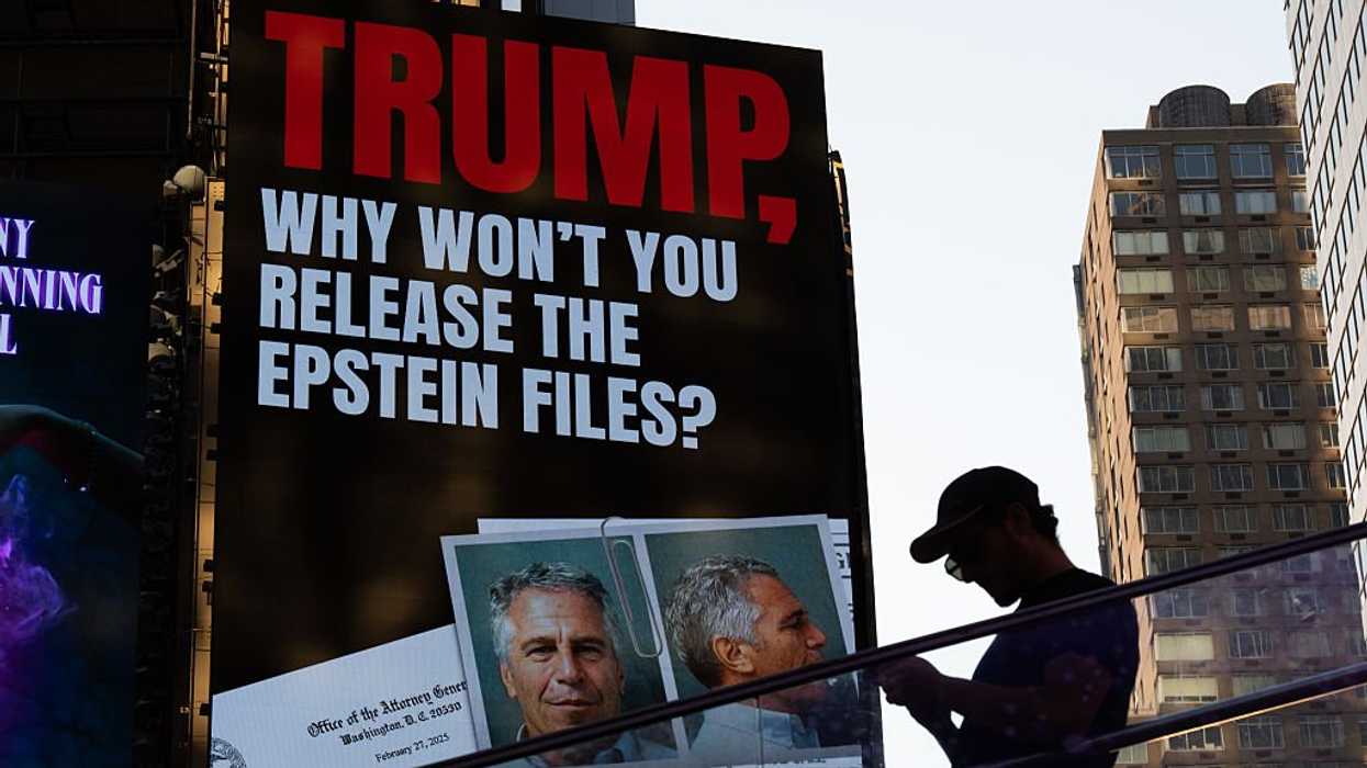 a billboard at times square calls for the release of the epstein files