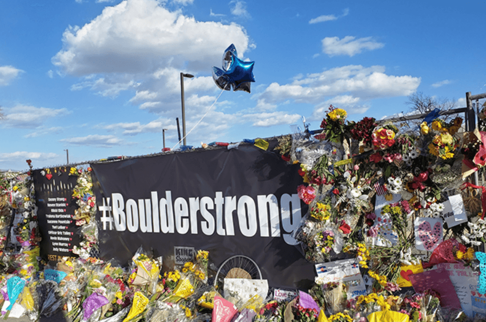 a boulder strong sign with flowers
