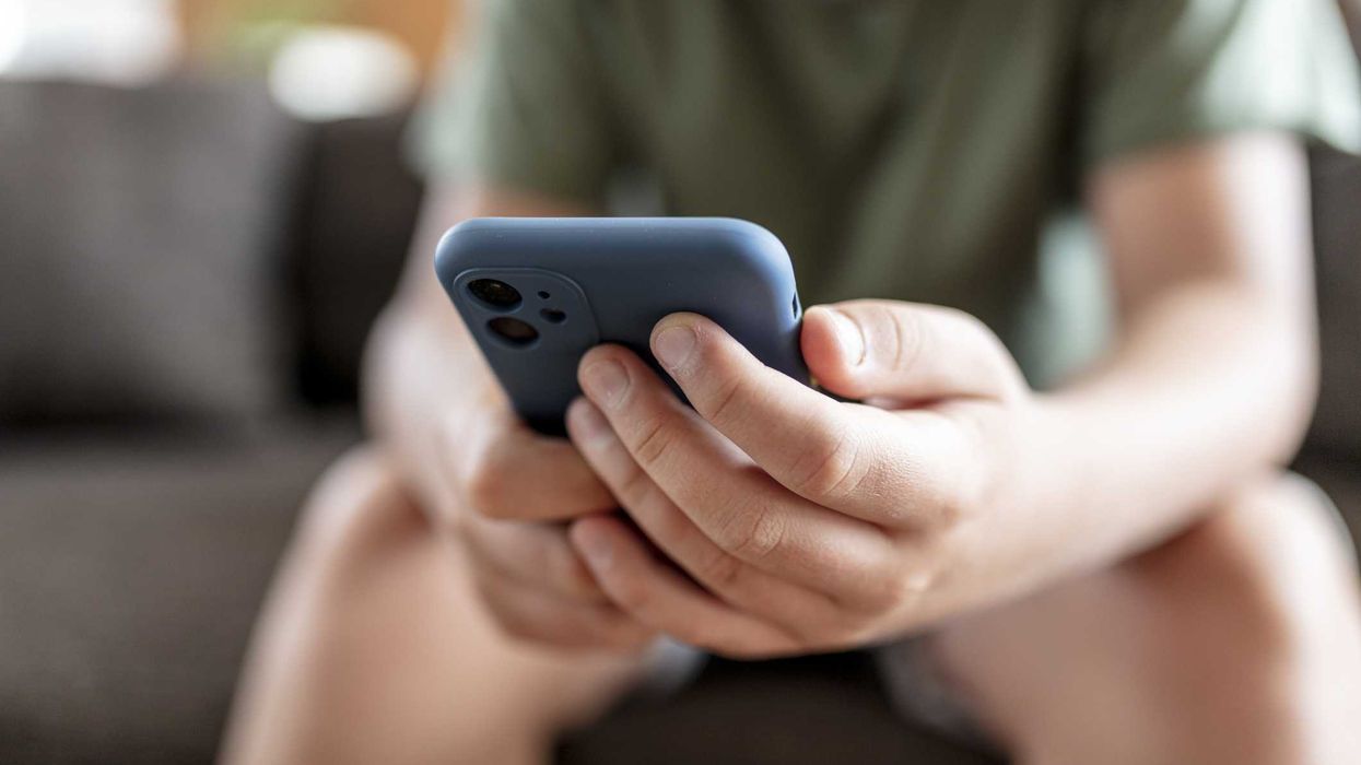 A child holding a smartphone.