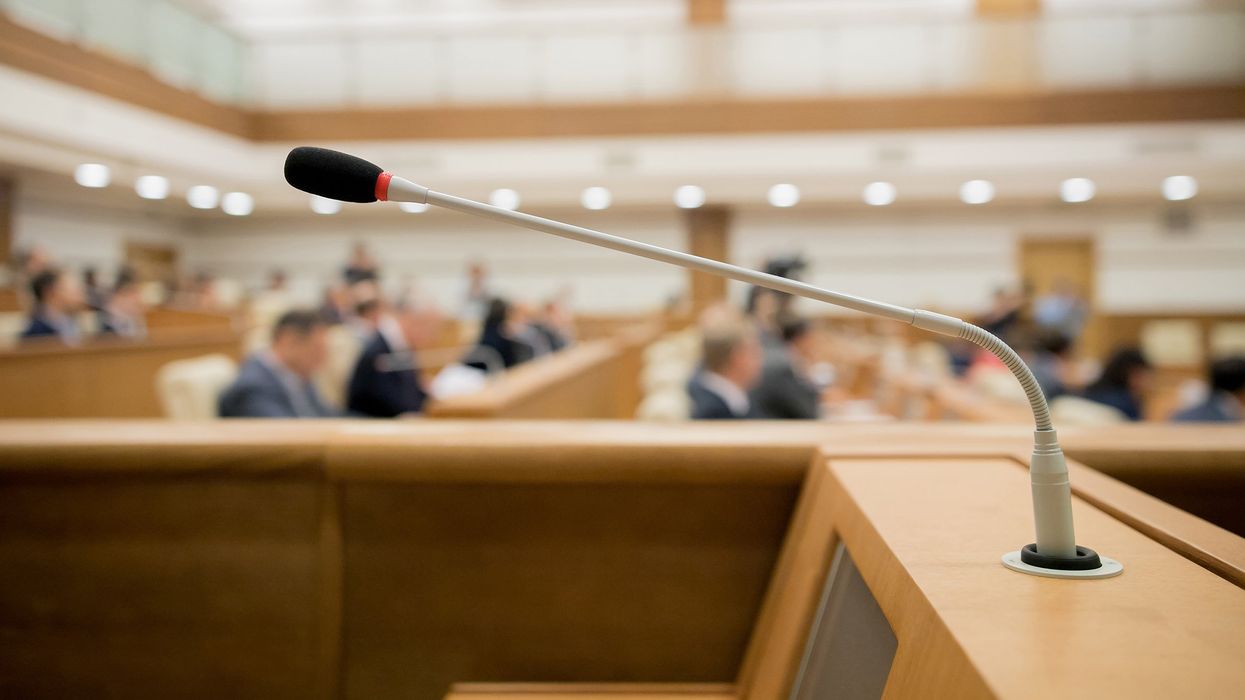 A close-up of a microphone during a session of government.