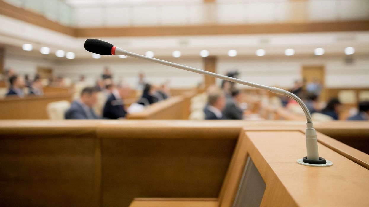 A close-up of a microphone during a session of government.
