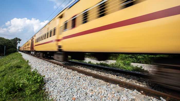 A close up of a train passing by quickly.