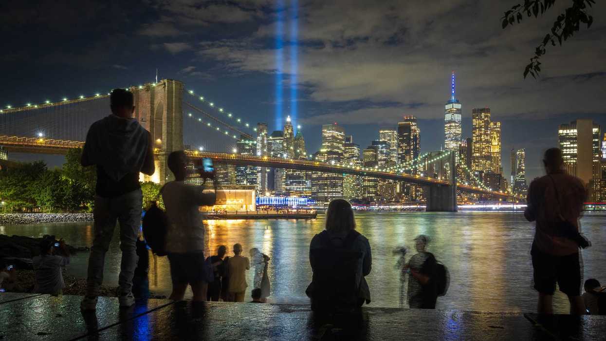 A crowd gathers to take in the September 11th memorial lights in Brooklyn, NY.