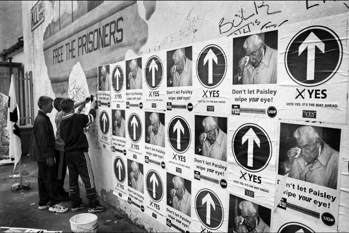 A group of youngsters help posting posters.