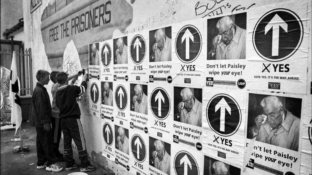 A group of youngsters help posting posters.
