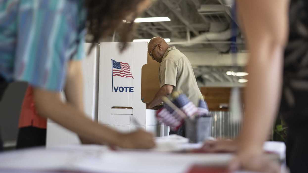 A person at a voting booth.