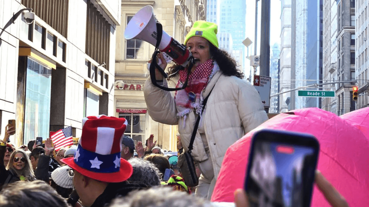 A person holding a megaphone in a crowd.