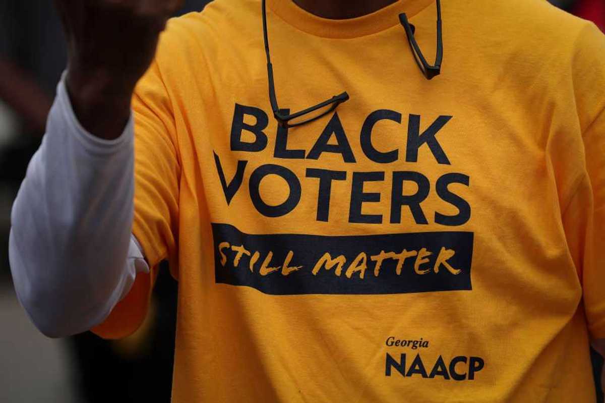 A person wearing a t-shirt that says, "Black Voters Still Matter."