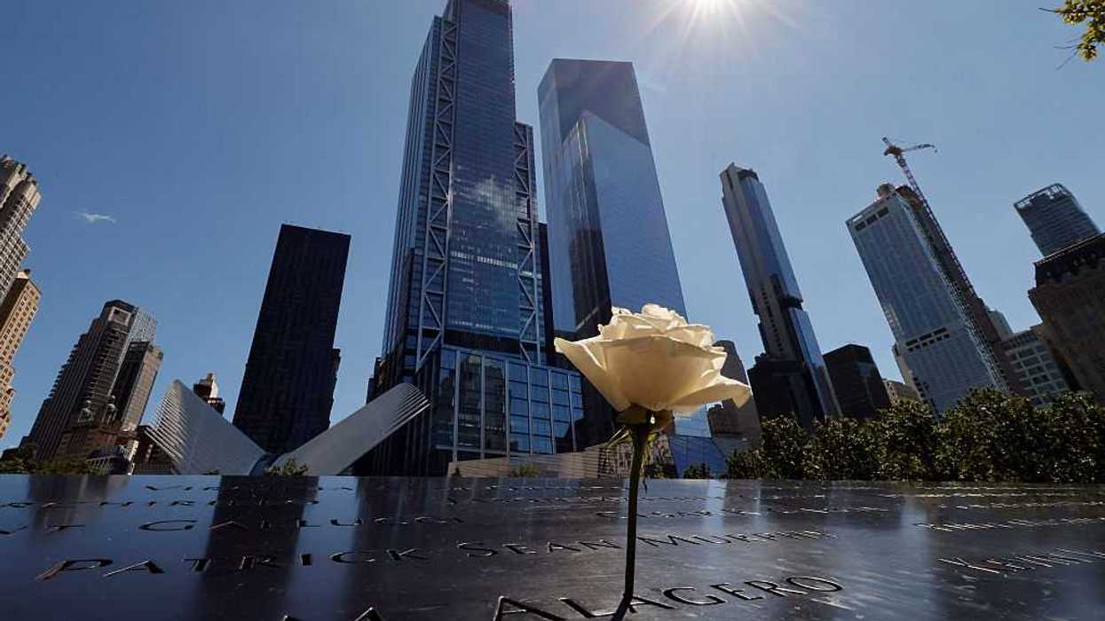 A rose stands on the 9/11 Memorial for the North Tower in front of 3 and 4 World Trade Center on September 7, 2026, in New York City.