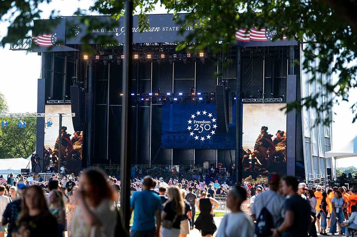 A stage on the national mall with a crowd of people before it.