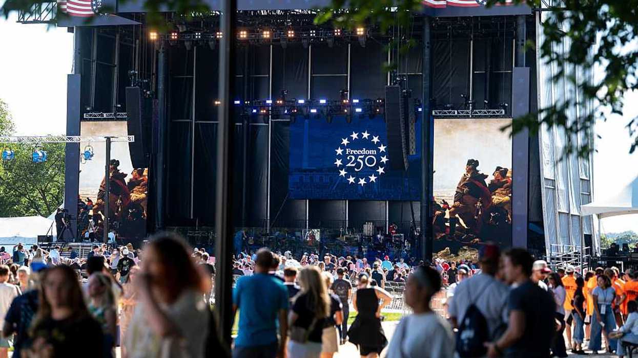 A stage on the national mall with a crowd of people before it.