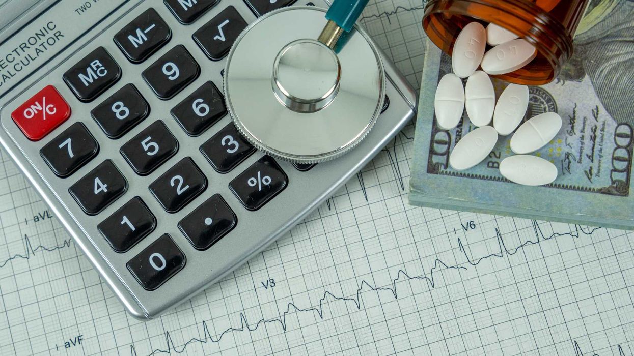 A stethoscope, calculator, pills, and cash.