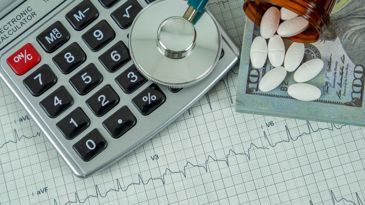 A stethoscope, calculator, pills, and cash.