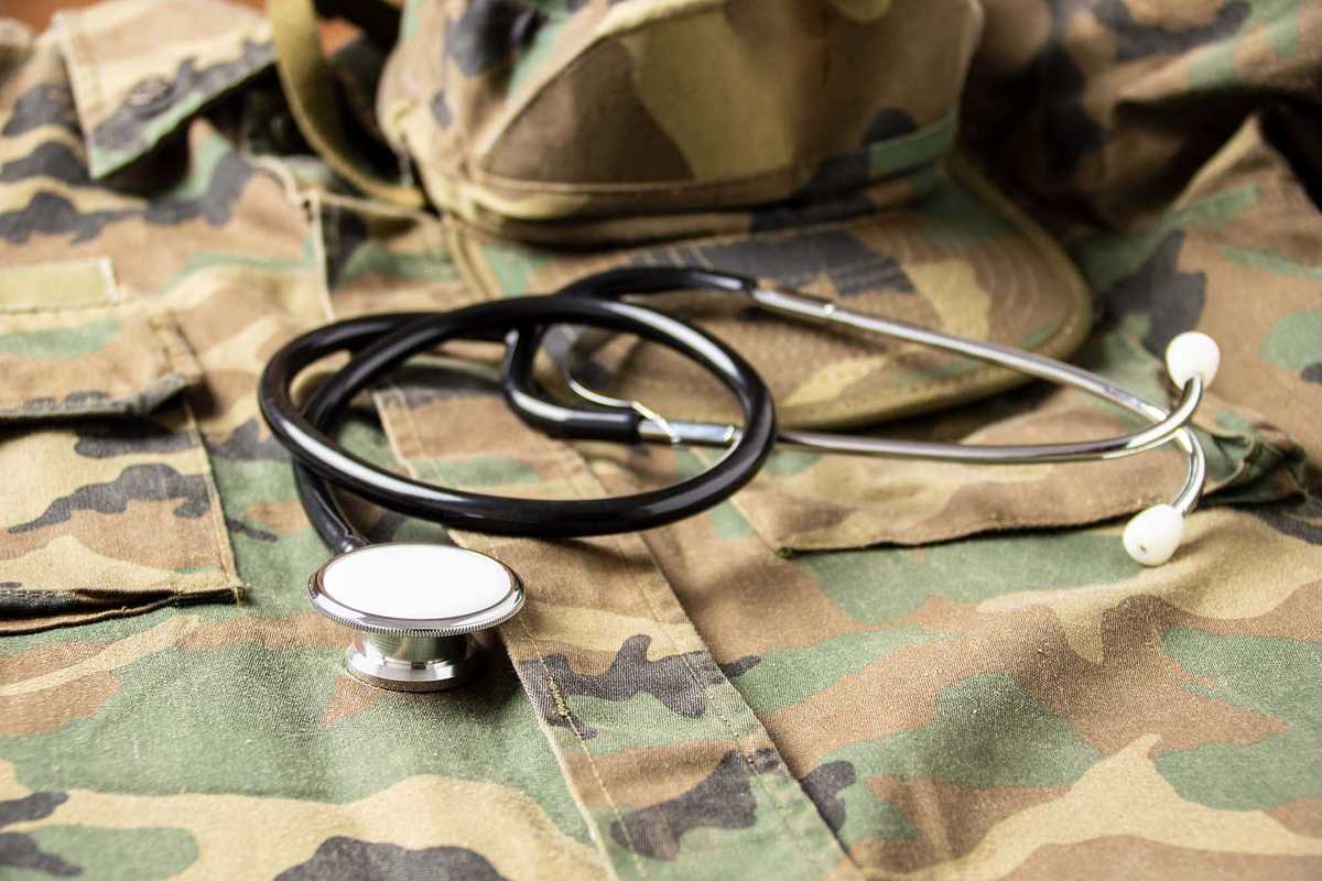 A stethoscope on top of the uniform a U.S. military solider.