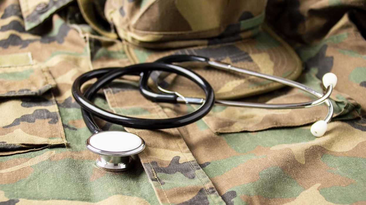 A stethoscope on top of the uniform a U.S. military solider.