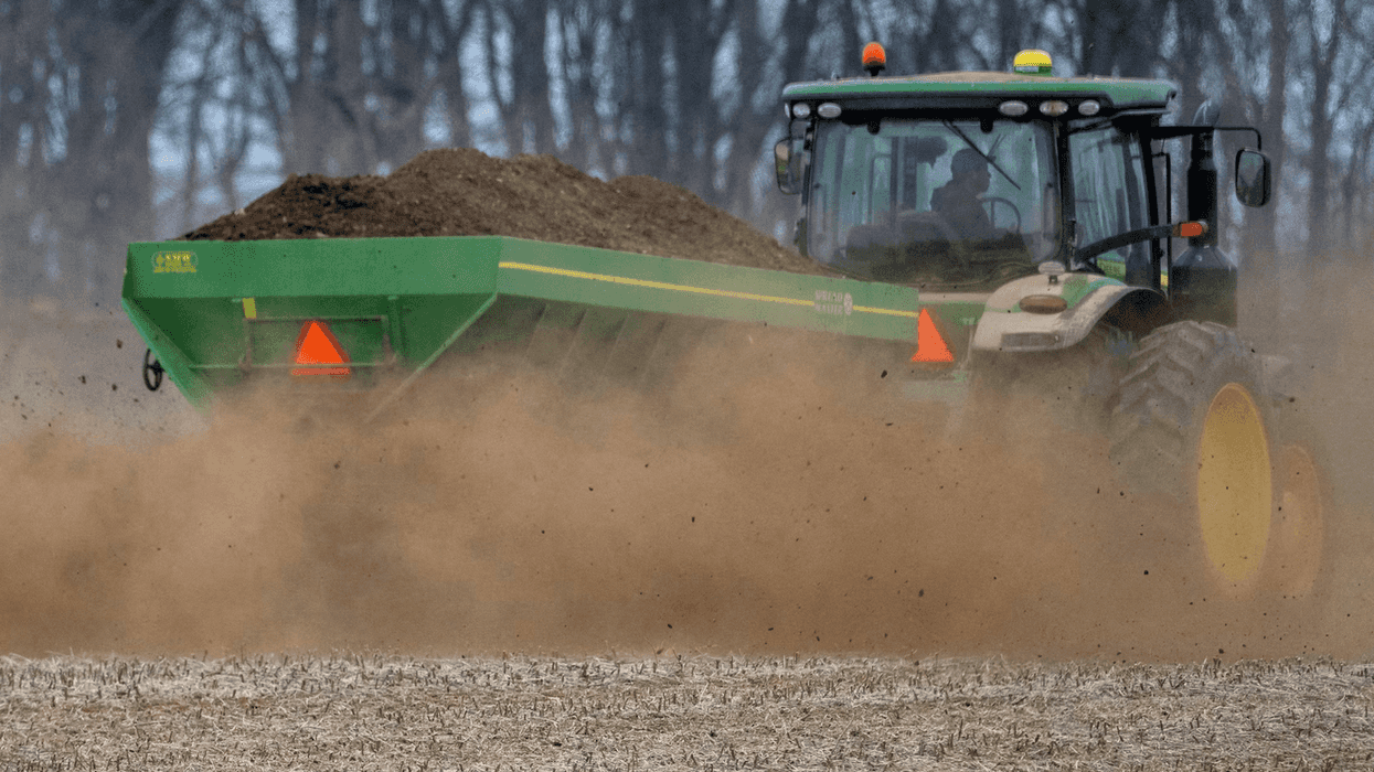 A tractor hauls dirt.