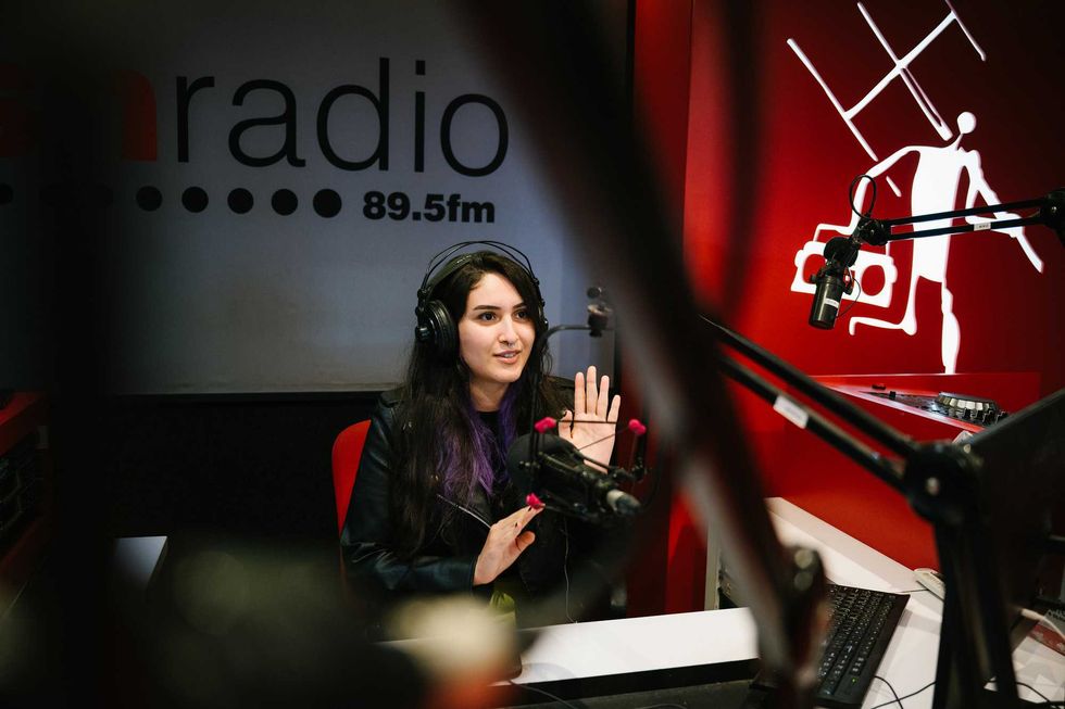 a woman gesturing while on radio