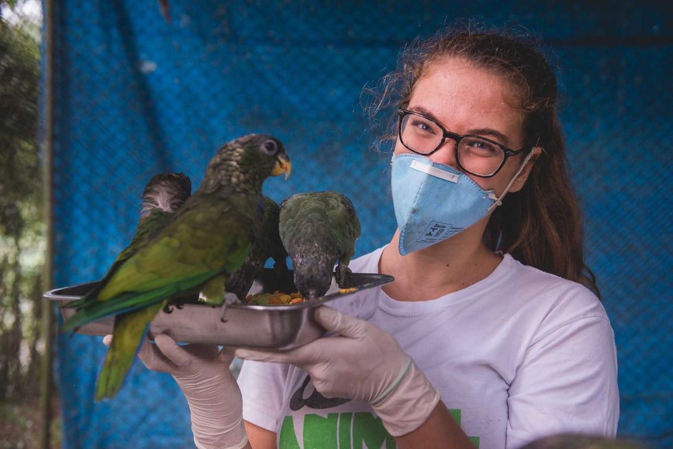 a woman holding birds