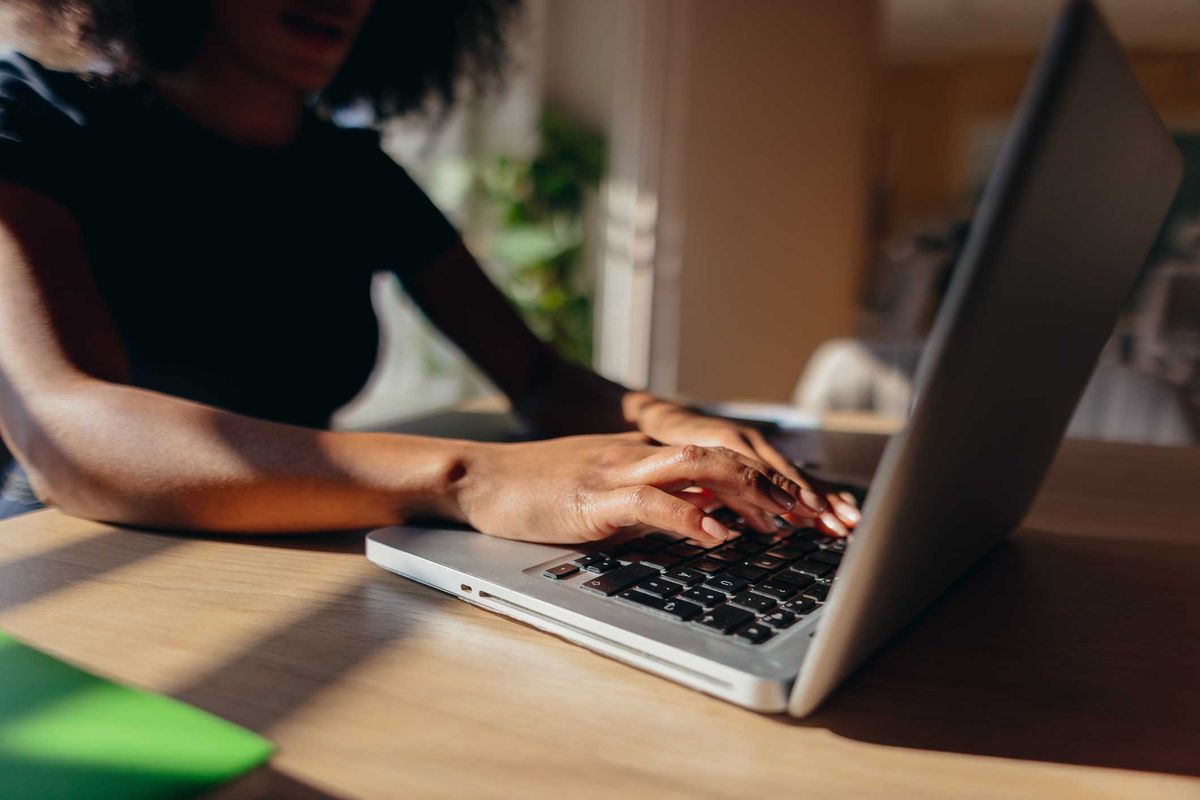 A woman typing on her laptop.