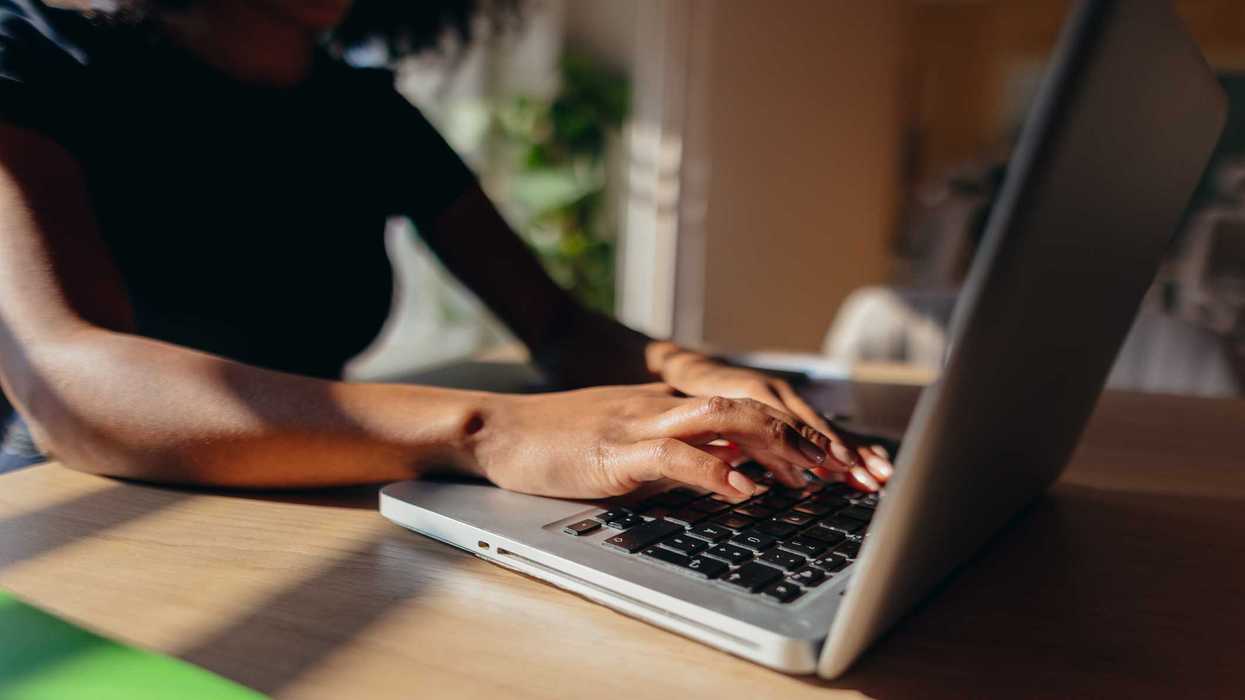 A woman typing on her laptop.