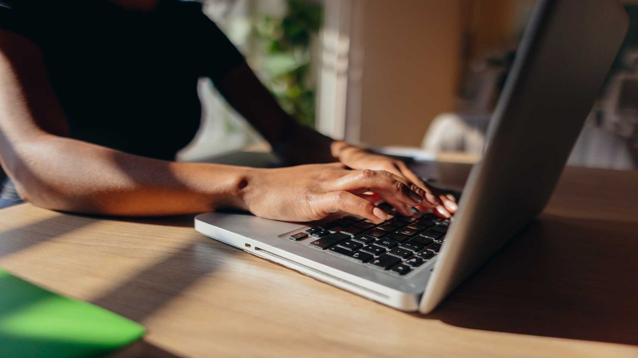 A woman typing on her laptop.