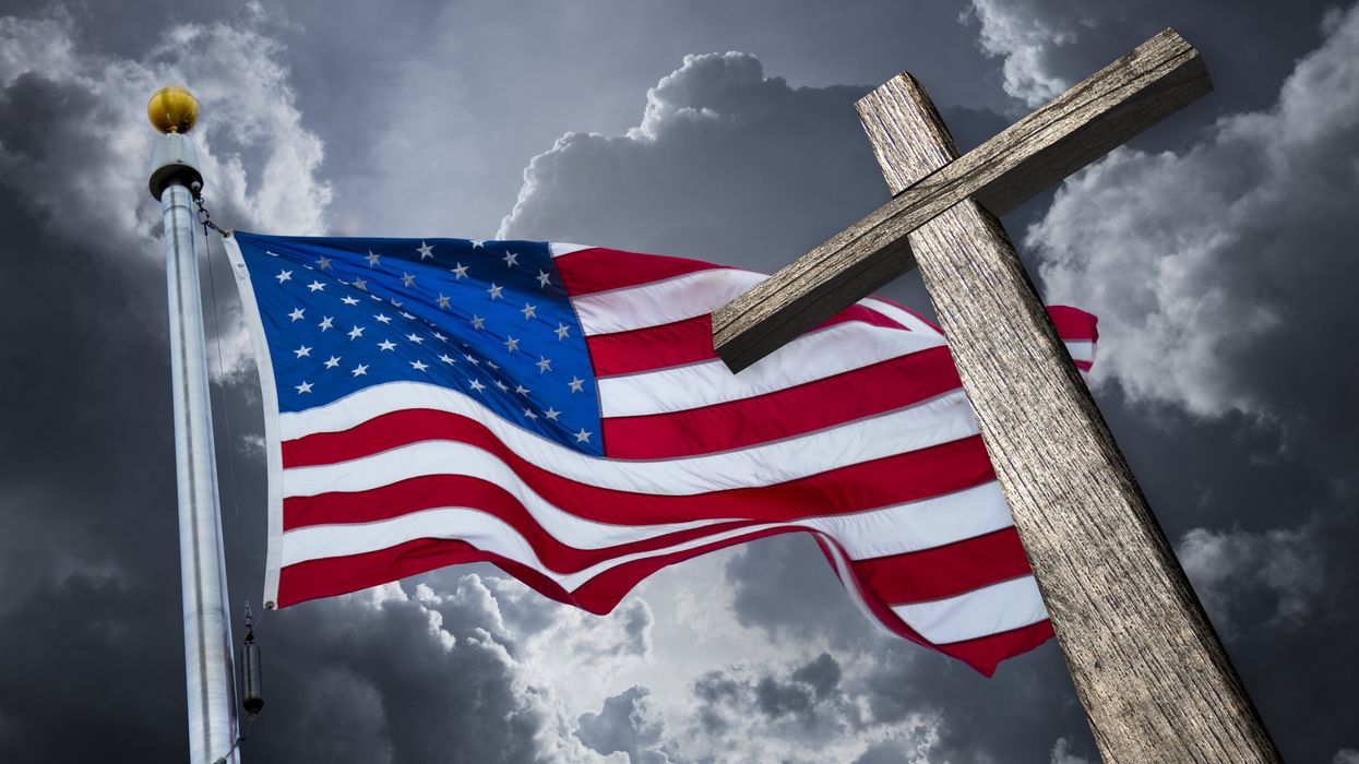 American flag and cross against a dark sky