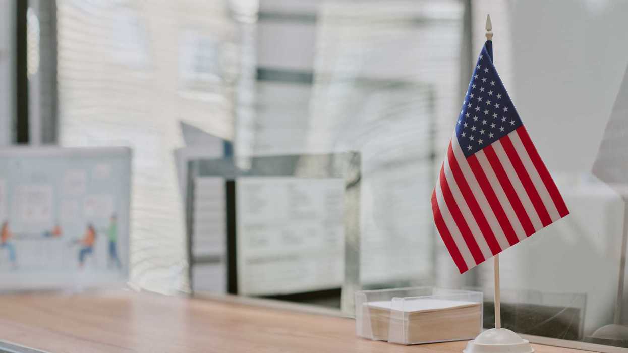 American Flag Displayed on Office Desk with Sunlight