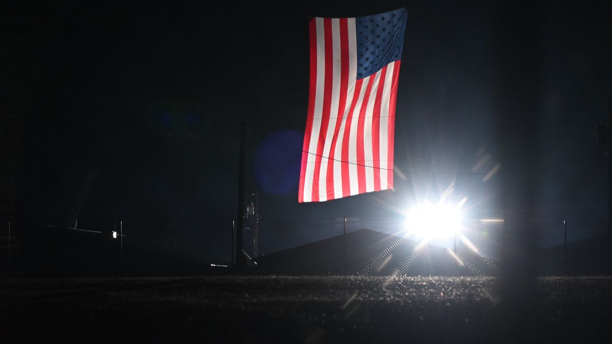 American flag hanging amid spotlights