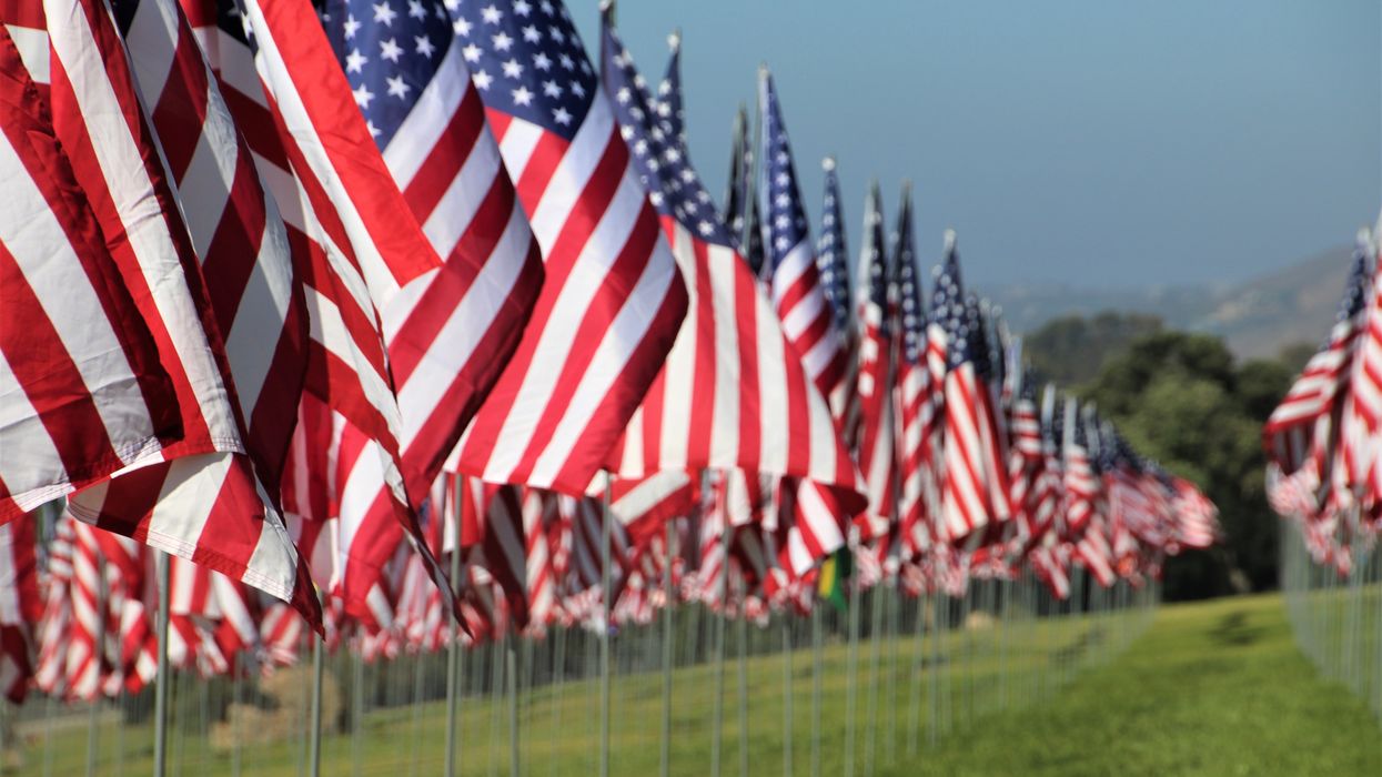American flags fly with a beautiful bright blue sky