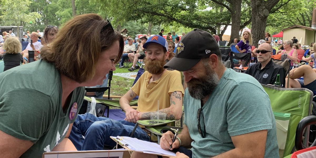 Amy Scott-Stoltz collects petition signatures at the Sioux River Folk Festival on Aug. 7.