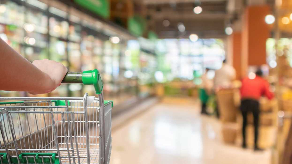 An empty grocery cart in a market.