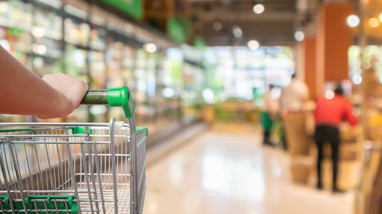 An empty grocery cart in a market.