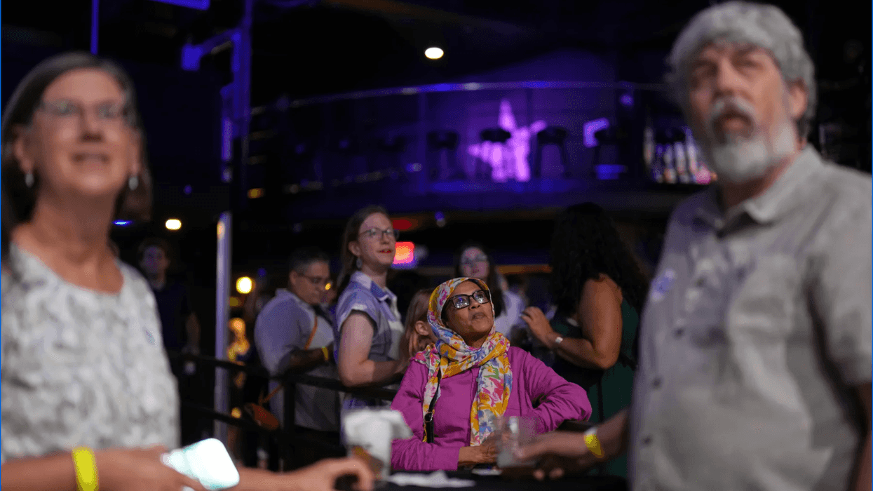 Attendees monitor results during an election night event.
