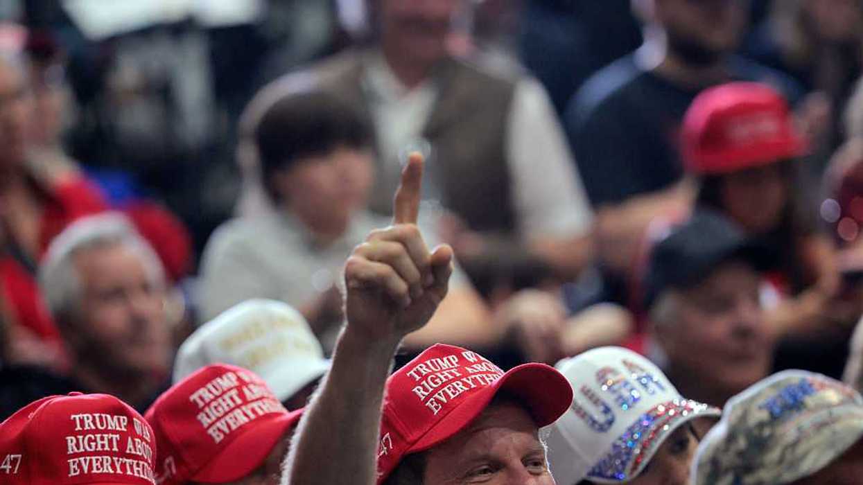Audience members listen as U.S. President Donald Trump.