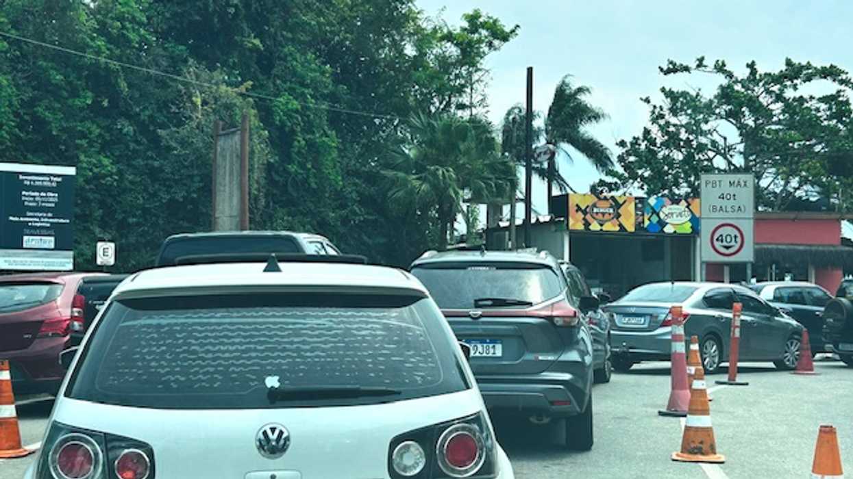 Automobiles wait in line to cross the São Sebastião Channel in Brazil
