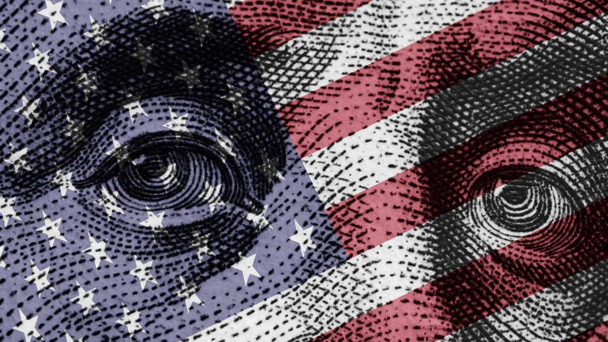 Benjamin Franklin's portrait on the one hundred-dollar bill alongside the US flag