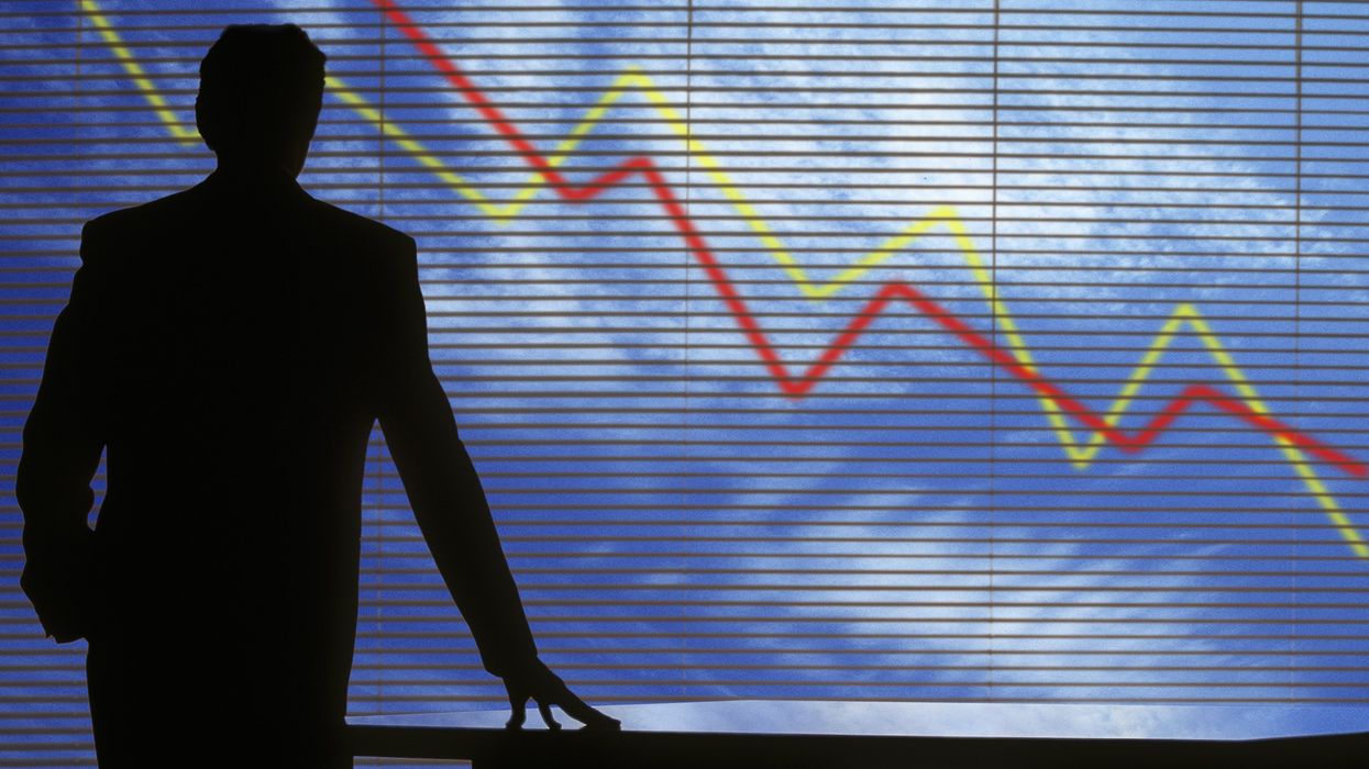 Business professional watching stocks go down.