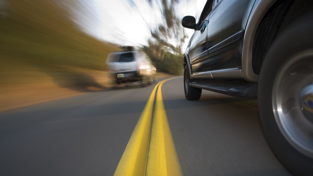 Cars driving on either side of the yellow lines