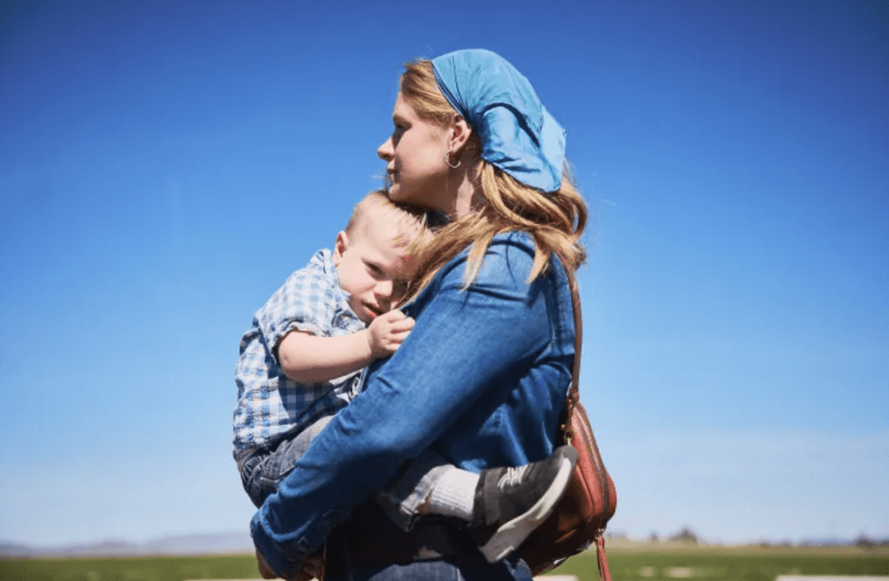 Cate Havstad-Casad holds her youngest son, Crosby, 2
