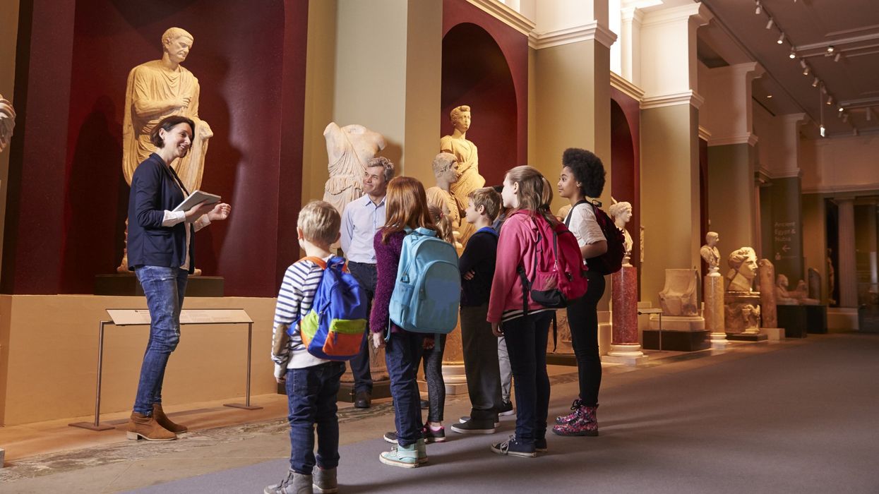 Children on a museum tour with a guide.