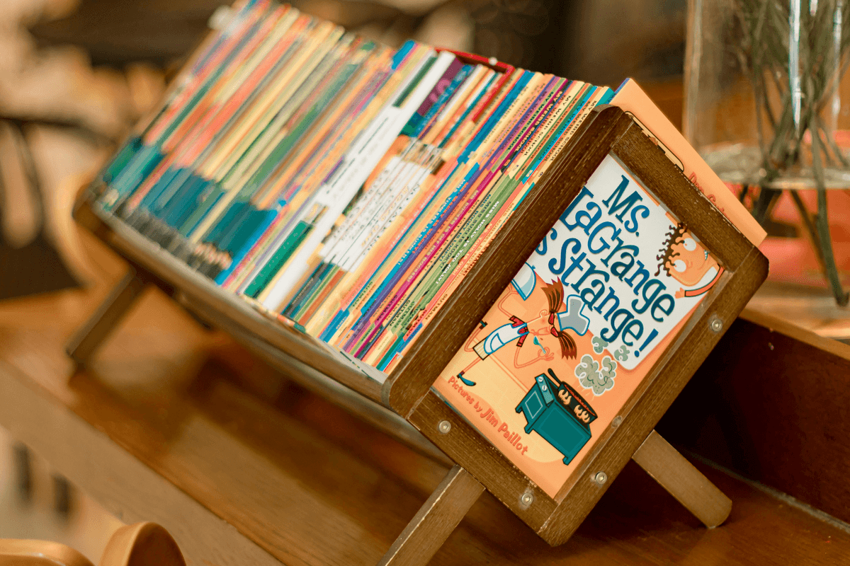 Children's books on a shelf.
