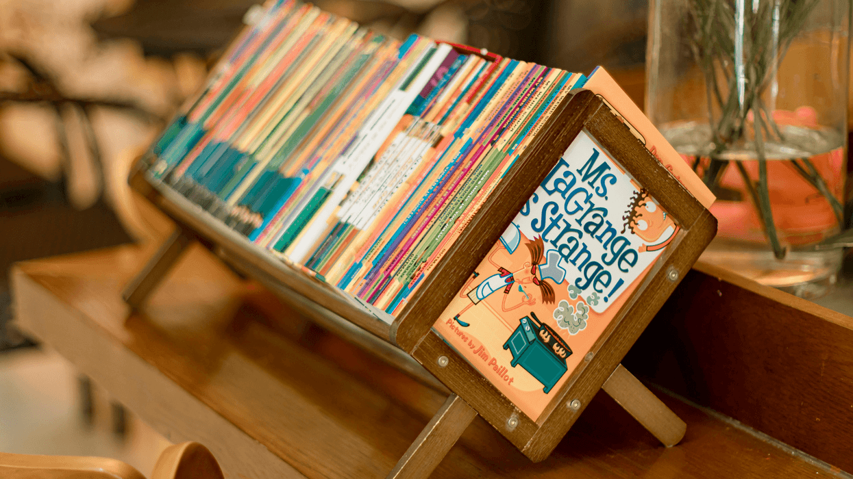 Children's books on a shelf.