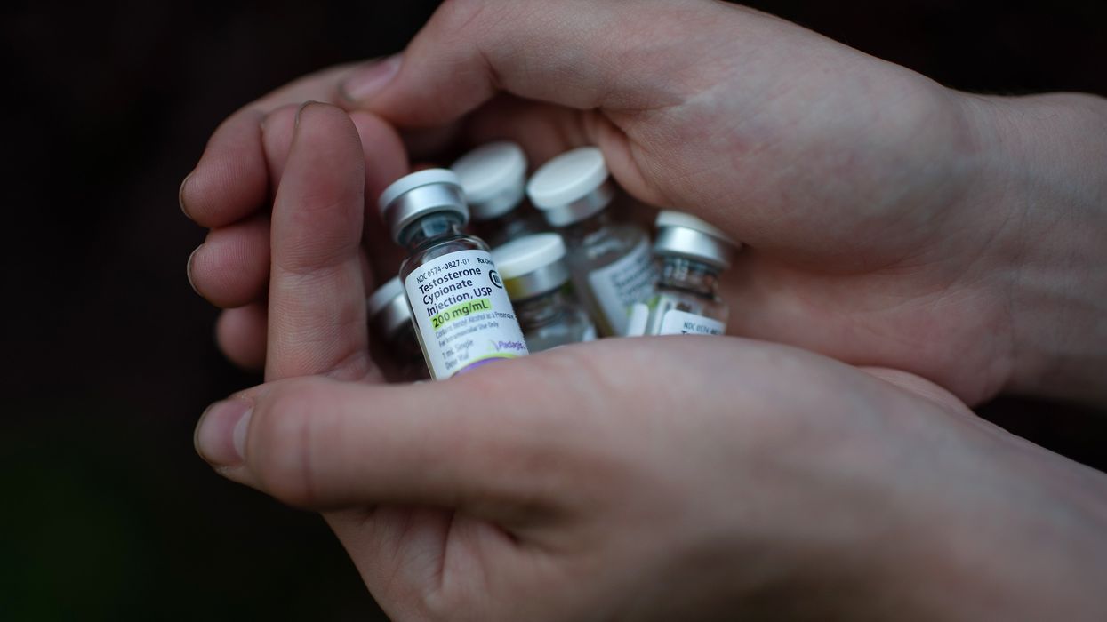 Close-up of hands holdering vials of medicine