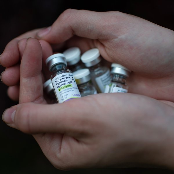 Close-up of hands holdering vials of medicine