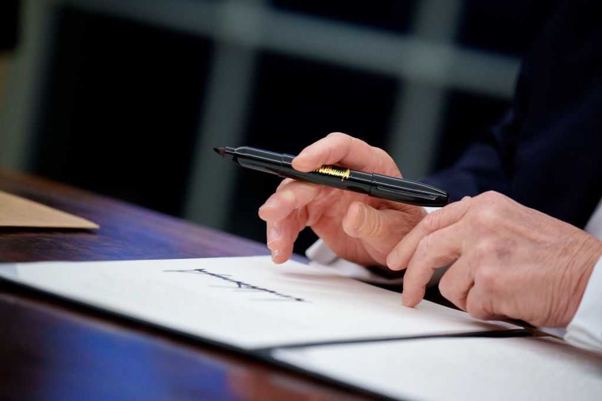 Close up of President Trump signing an excutive order.