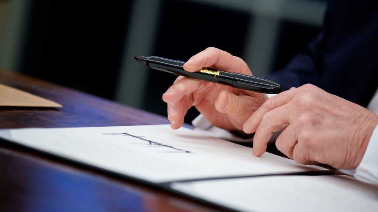 Close up of President Trump signing an excutive order.