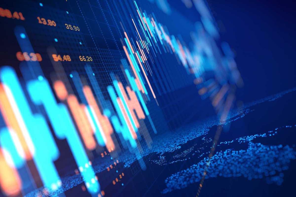 Close up of stock market chart on a glowing particle world map.