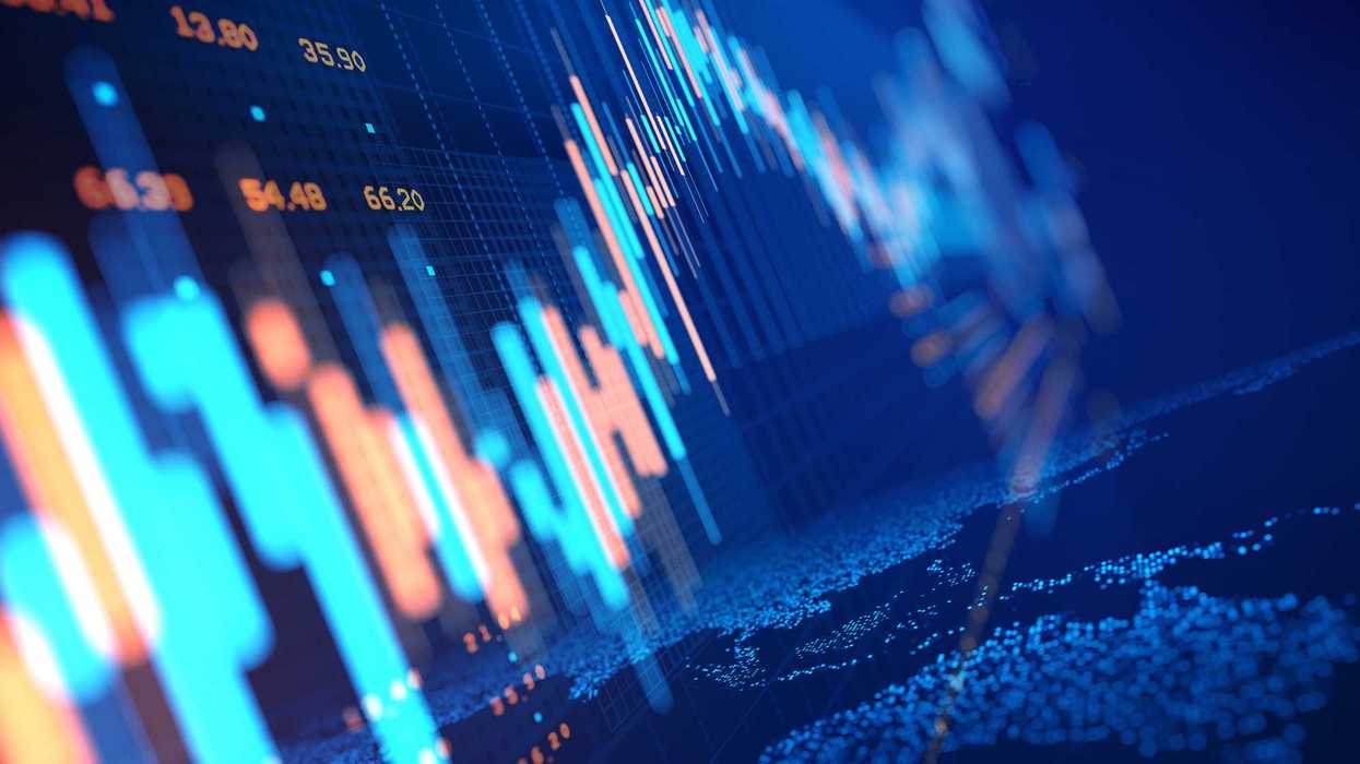 Close up of stock market chart on a glowing particle world map.
