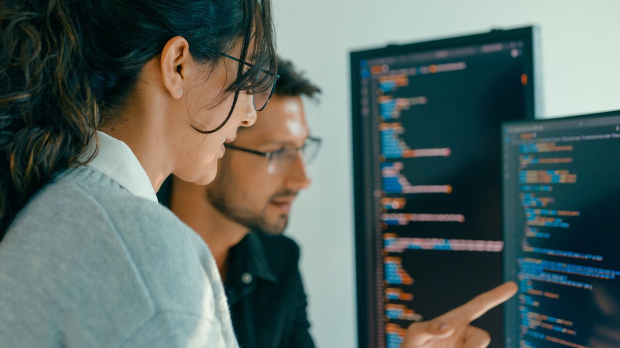 Closeup of Software engineering team engaged in problem-solving and code analysis