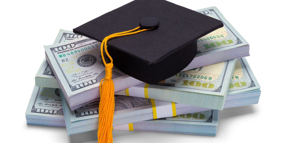 college graudation cap on a pile of money